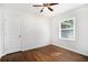 Cozy bedroom featuring hardwood floors, a window, and a white door at 2308 Scotty Cir, Decatur, GA 30032