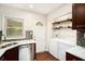 Modern kitchen including stainless steel dishwasher, laundry area, and white countertop at 2308 Scotty Cir, Decatur, GA 30032