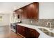 Well-lit kitchen boasting dark wood cabinets, sleek stainless steel appliances, and white quartz countertops at 2308 Scotty Cir, Decatur, GA 30032
