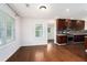 Bright living room featuring hardwood floors, large windows, and an open kitchen with stainless steel appliances at 2308 Scotty Cir, Decatur, GA 30032