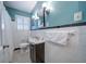 Bright bathroom featuring black and white patterned flooring, a dark vanity, and fresh towels at 26 Kensington Rd, Avondale Estates, GA 30002