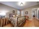 Cozy bedroom featuring hardwood floors, shuttered windows, and a floral-patterned bedspread at 26 Kensington Rd, Avondale Estates, GA 30002