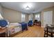 Spacious bedroom features hardwood floors, comfortable seating, and shuttered windows for natural light at 26 Kensington Rd, Avondale Estates, GA 30002