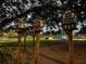 Charming decorative birdhouses on wooden posts add character to this whimsical landscape with a playground in the background at 26 Kensington Rd, Avondale Estates, GA 30002