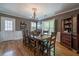 Charming dining area features hardwood floors, white wainscoting, and backyard views at 26 Kensington Rd, Avondale Estates, GA 30002