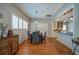 Bright dining room featuring hardwood floors, plantation shutters, and an adjacent kitchen at 26 Kensington Rd, Avondale Estates, GA 30002