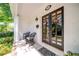 Inviting front porch features seating and decor, leading to an elegant front door at 26 Kensington Rd, Avondale Estates, GA 30002