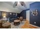 Cozy living room featuring dark blue walls, hardwood floors, and comfortable seating arrangement at 26 Kensington Rd, Avondale Estates, GA 30002