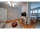 Cozy main bedroom featuring a brick accent wall, hardwood floors, and comfortable seating at 26 Kensington Rd, Avondale Estates, GA 30002