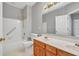 Bathroom with dual vanity, bathtub and shower combination, and neutral color palette at 2825 Harbor Cove Ct, Cumming, GA 30041
