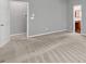 Bedroom with neutral paint and carpet featuring an attached bathroom view at 2825 Harbor Cove Ct, Cumming, GA 30041