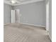 Bedroom with neutral paint and carpet, featuring ample space and doorway to hallway at 2825 Harbor Cove Ct, Cumming, GA 30041