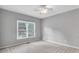 Bedroom featuring a neutral color palette, window views, and ceiling fan at 2825 Harbor Cove Ct, Cumming, GA 30041
