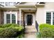 Inviting front entrance with stone accents, a cozy porch, and manicured greenery at 2825 Harbor Cove Ct, Cumming, GA 30041