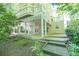 A serene home exterior with multiple decks surrounded by lush greenery, blending nature with outdoor living spaces at 2825 Harbor Cove Ct, Cumming, GA 30041