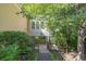 Charming home exterior with a walkway surrounded by lush greenery, offering a serene and private entrance at 2825 Harbor Cove Ct, Cumming, GA 30041