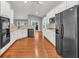 A lovely kitchen featuring white cabinetry, a black refrigerator, hardwood floors, and stainless steel appliances at 2825 Harbor Cove Ct, Cumming, GA 30041