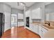 Bright kitchen with white cabinets, hardwood flooring, and sleek black appliances for a modern look at 2825 Harbor Cove Ct, Cumming, GA 30041