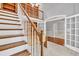 Open living space featuring staircase, built-in shelving, and large windows at 2825 Harbor Cove Ct, Cumming, GA 30041