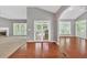 Inviting living room with hardwood floors, fireplace, and ample natural light streaming through large windows at 2825 Harbor Cove Ct, Cumming, GA 30041