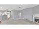 Spacious open concept living room with carpeted floors, a fireplace, and arched entryway at 2825 Harbor Cove Ct, Cumming, GA 30041