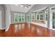 Bright living room featuring hardwood floors, neutral paint, and large windows with a built-in bench at 2825 Harbor Cove Ct, Cumming, GA 30041