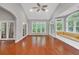 Bright living room featuring hardwood floors, neutral paint, and large windows with a built-in bench at 2825 Harbor Cove Ct, Cumming, GA 30041