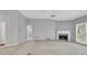 Bright open concept living room with carpeted floors, a fireplace, large windows and arched entryway at 2825 Harbor Cove Ct, Cumming, GA 30041