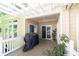 Covered patio with a ceiling fan, outdoor grill, and multiple sliding doors at 2825 Harbor Cove Ct, Cumming, GA 30041