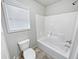 Clean bathroom featuring a shower-tub and a window at 4449 Sierra Creek Dr, Hoschton, GA 30548