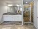 Modern primary bathroom featuring a glass shower, double vanity and tile floor at 4449 Sierra Creek Dr, Hoschton, GA 30548
