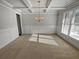 Dining room with coffered ceilings, chair rail, and modern chandelier at 4449 Sierra Creek Dr, Hoschton, GA 30548