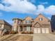 Beautiful two-story brick home with a two-car garage, manicured landscaping, and a welcoming front porch at 4449 Sierra Creek Dr, Hoschton, GA 30548