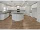 Modern kitchen featuring white cabinetry, granite countertops, and a large island at 4449 Sierra Creek Dr, Hoschton, GA 30548