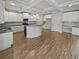 Bright kitchen with white cabinets, a large island, and stainless steel appliances at 4449 Sierra Creek Dr, Hoschton, GA 30548