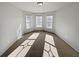 Well-lit living room featuring neutral carpet, recessed lighting, and a bay window at 4449 Sierra Creek Dr, Hoschton, GA 30548
