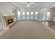 Spacious living room showcasing a fireplace and ample natural light at 4449 Sierra Creek Dr, Hoschton, GA 30548