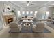 Bright living room featuring a fireplace, large windows, and neutral decor at 4449 Sierra Creek Dr, Hoschton, GA 30548