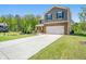 Well-kept two-story home with a long driveway and lush green lawn at 6900 Oak Valley Dr, Douglasville, GA 30134