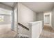 Hallway with carpet, white trim, and stairs with wood and white banister at 6900 Oak Valley Dr, Douglasville, GA 30134