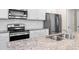 Modern kitchen with stainless steel appliances, granite countertops, and stylish backsplash at 6900 Oak Valley Dr, Douglasville, GA 30134