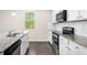 Modern kitchen with granite countertops, stainless steel appliances, and white cabinetry at 6900 Oak Valley Dr, Douglasville, GA 30134