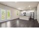 Open-concept living room and kitchen with stainless steel appliances and patio doors at 6900 Oak Valley Dr, Douglasville, GA 30134