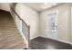 Carpeted staircase with a white door and dark flooring leading to the upper level at 6900 Oak Valley Dr, Douglasville, GA 30134