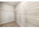 Walk-in closet with white wire shelving and neutral carpet at 6900 Oak Valley Dr, Douglasville, GA 30134