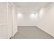 Basement area with ample storage, white walls, gray floor and recessed lighting at 11760 Stratham Dr, Alpharetta, GA 30009