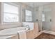 Luxurious bathroom featuring a soaking tub and a separate glass-enclosed shower at 11760 Stratham Dr, Alpharetta, GA 30009