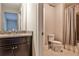 Neutral bathroom with granite countertop, dark cabinets, and tile shower with shower curtain at 11760 Stratham Dr, Alpharetta, GA 30009