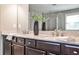 Bathroom with a double vanity, granite countertop, and a large mirror at 11760 Stratham Dr, Alpharetta, GA 30009