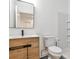 Modern bathroom features a wooden vanity with a sleek mirror and a shower with subway tile at 11760 Stratham Dr, Alpharetta, GA 30009